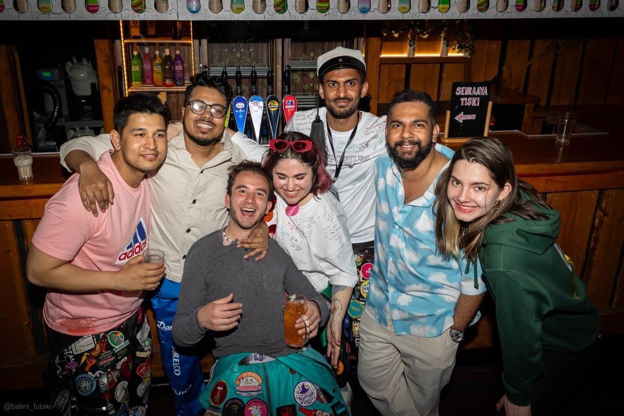 Students posing at the bar with drinks